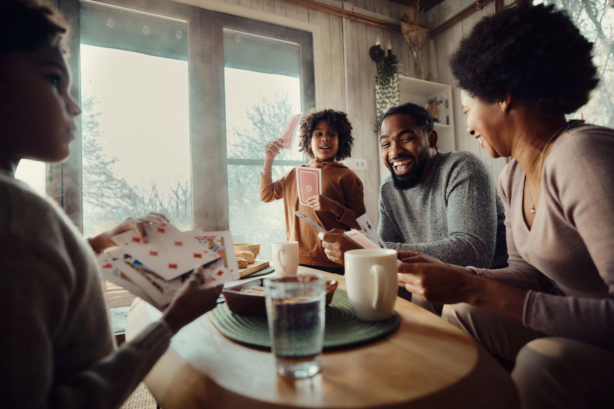 Black family playing board game